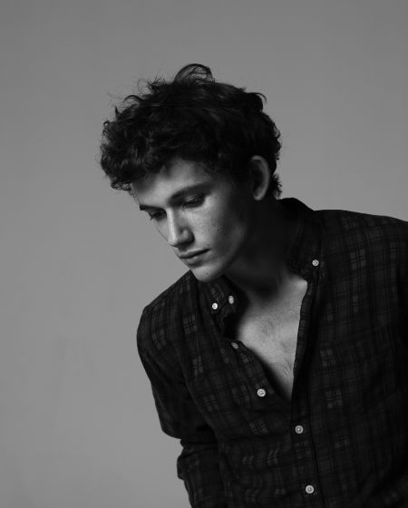 Eli Brown in a black shirt poses for a picture.